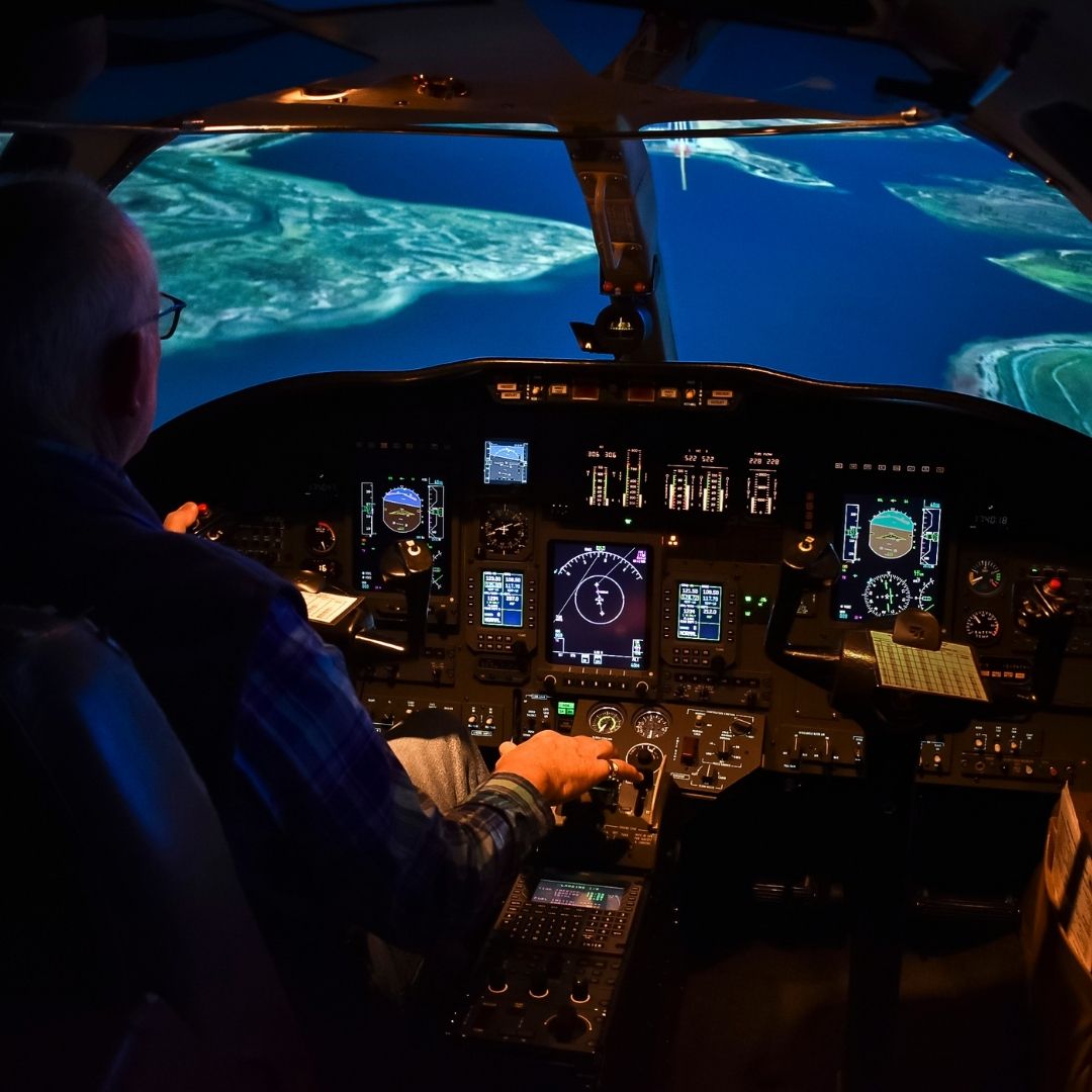 An instructor flying a flight simulator